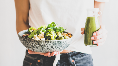 Bol de salade verte avec smoothie detox maison.