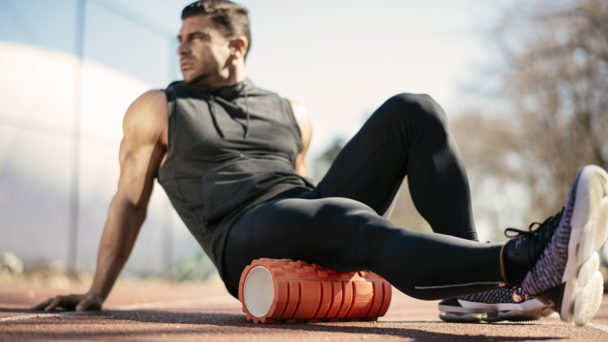 Man using foam roller for post-workout muscle recovery.