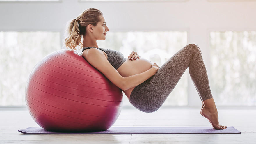 Prenatal fitness with exercise ball for core and back support.